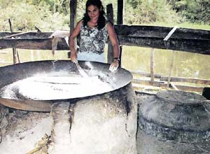Socorro Rodrigues da Silva toasting tapioca on a clay oven.