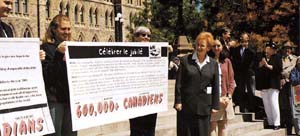Dianne  Marleau, Minister for International Cooperation, receives a symbolic petition from Jubilee 2000 debt campaign activists.  Credit: Sara Stratton/Canadian Ecumenical Jubilee Initiative