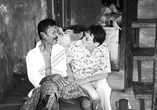 (Credit Beverley Vantomme) Scarboro lay missioner Maggie Smith, a registered practical nurse, visits with a resident at a Hindu shelter for the elderly in New Amsterdam, Guyana.