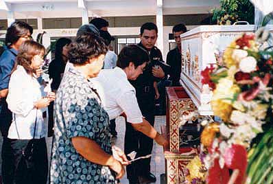 Praying with the monks and before the coffin at Nok's mother's burial ritual.