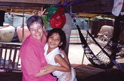 Little Bin, daughter of a friend who teaches at the Centre where Dorothy Novak volunteers, welcomes Dorothy to her home with friendship and joy