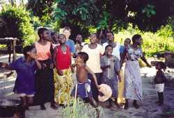 Villagers joyfully welcome Scarboro lay missioner Mary Olenick who often accompanies the Rosarian Sisters on their travels. Mzuzu, Malawi