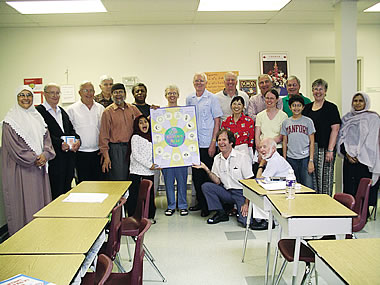 During a joyous day-long visit to the Islamic Foundation mosque in Toronto, Scarboro lay and priest missioners present their hosts with a gift of the Golden Rule poster.