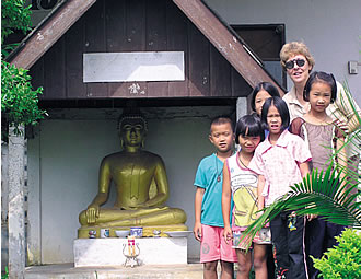Susan Keays with little ones at the Camillian Social Centre.