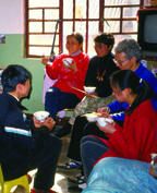 Louise Malnachuk enjoying a meal at home with her students. China.
