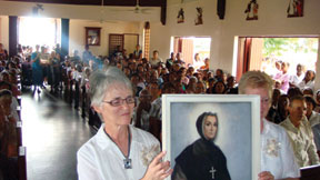 At the anniversary mass, Sr. Mary Buckley (left), General Councillor of the Grey Sisters, and Sr. Fay Edmonds, General Superior, from the Sisters’ mother house in Pembroke, Ontario, carrying a portrait of St. Marguerite d’Youville, their foundress.