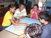 L-R: An afternoon game of Scrabble at the Grupo de Desemvolvemento Familiar, (Association for Family Support) with (L-R) Tatiele, Sr. Lucy Lee, Cícera, and Bernardo.