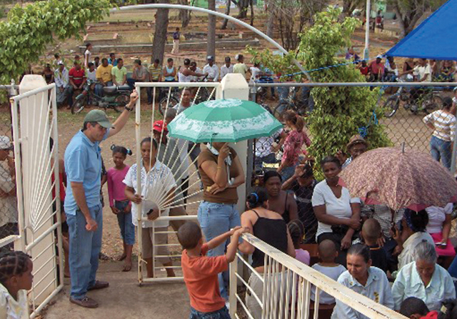 Groups of people await their turn for health care outside a temporary clinic.