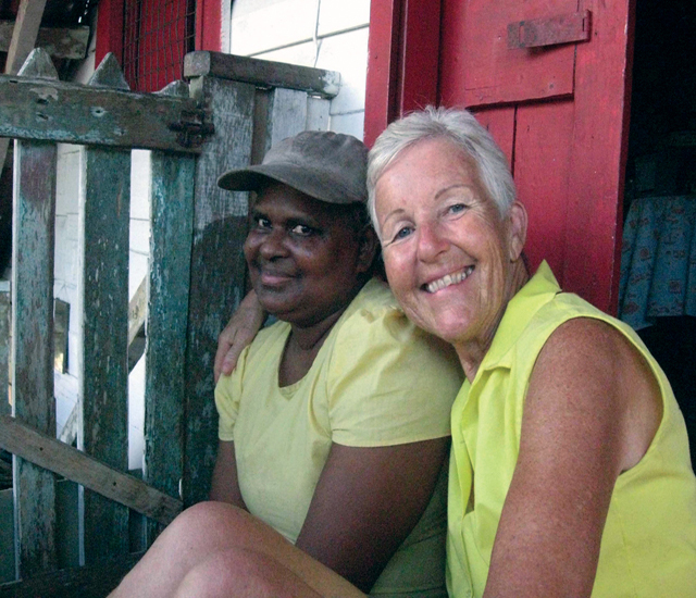 Lalita welcomes her neighbour, Scarboro lay missioner Kate O’Donnell, for a visit on her front steps. Guyana
