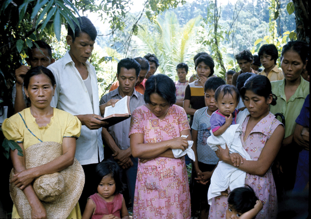 Siyong leads the prayer for a murdered farmer during the oppressive years (1972 to 1981) of Martial Law in the Philippines.