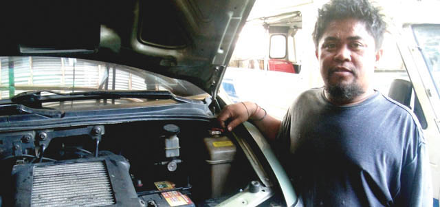 Renen Nuñez, brother of Sister Lorie Nuñez, at his auto mechanic shop. Gingoog, Philippines.