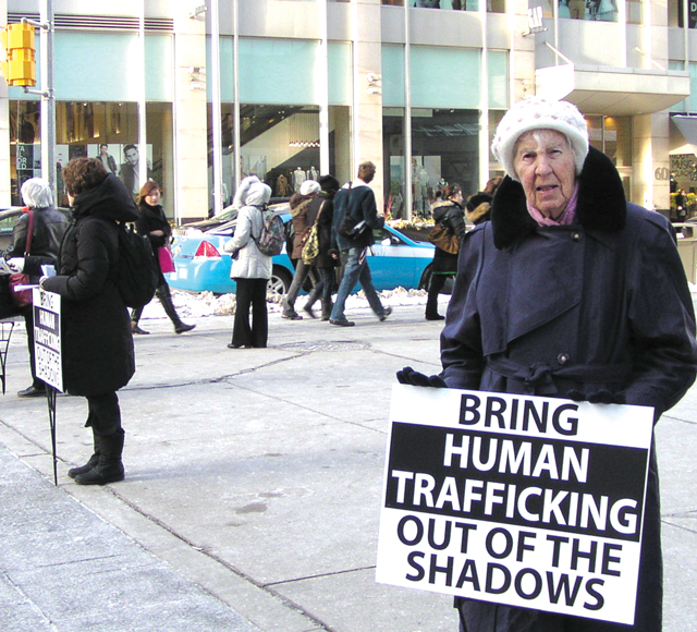 Sister Mary Hughes and other OLMs join CNWE to stand witness in downtown Toronto to the tragedy of human trafficking.