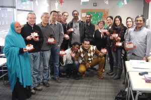 Beverley at Christmastime with her students from Ethiopia, Eritrea, South Korea, China, Congo, Libya, Afghanistan, Iran, Columbia, and Burma who are learning English. Her husband, Ray, made the sleighs that are full of candy. 