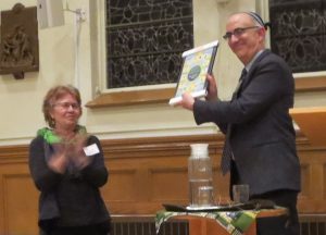 Rabbi Elkin holding the Golden Rule Poster presented by Sr. Lucy