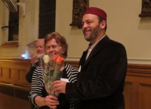 Sr. Lucy holding three flowers that were just presented to her - one for each Perspective in this 3-part Series