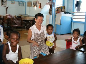 Former Scarboro missioner Estrela De Sousa with orphaned children in Guyana.