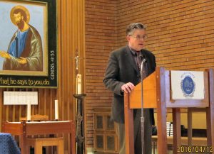 As the evening's moderator, Fr. Scott Lewis, VP and Dean at Regis College introduces the two speakers