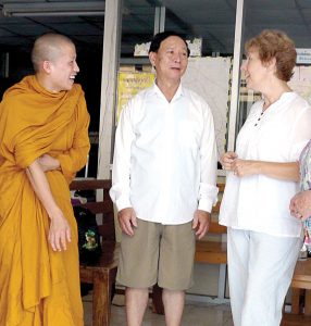 Former Scarboro lay missioner Susan Keays with Mr. Hsai, director of the Migrant Centre where Susan taught, and a Buddhist monk studying at the Centre. Thailand. 2010